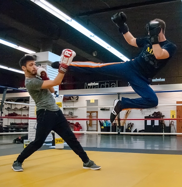 Save_kicking_in_air savate classes or french kickboxing classes in Seattle